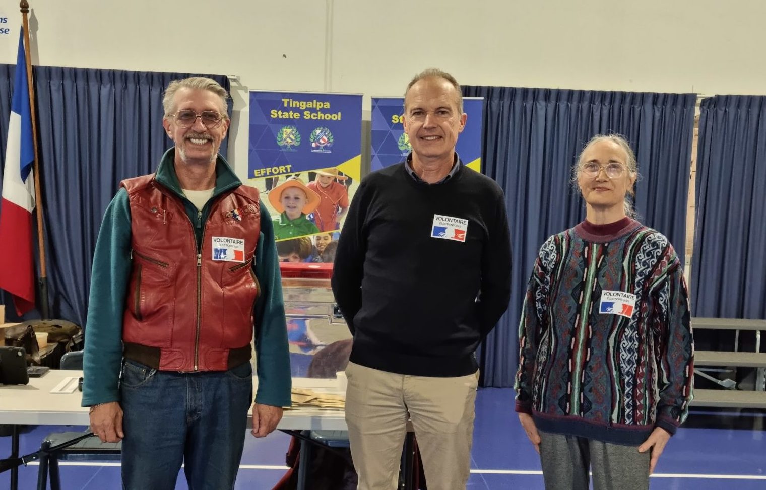 French election polling station officials (l-r) Frank Lamy, assessor, Alain Etchegaray, station president, and Jocelyne Poirier, assessor, prepare for duty at Tingalpa State School on June 19.